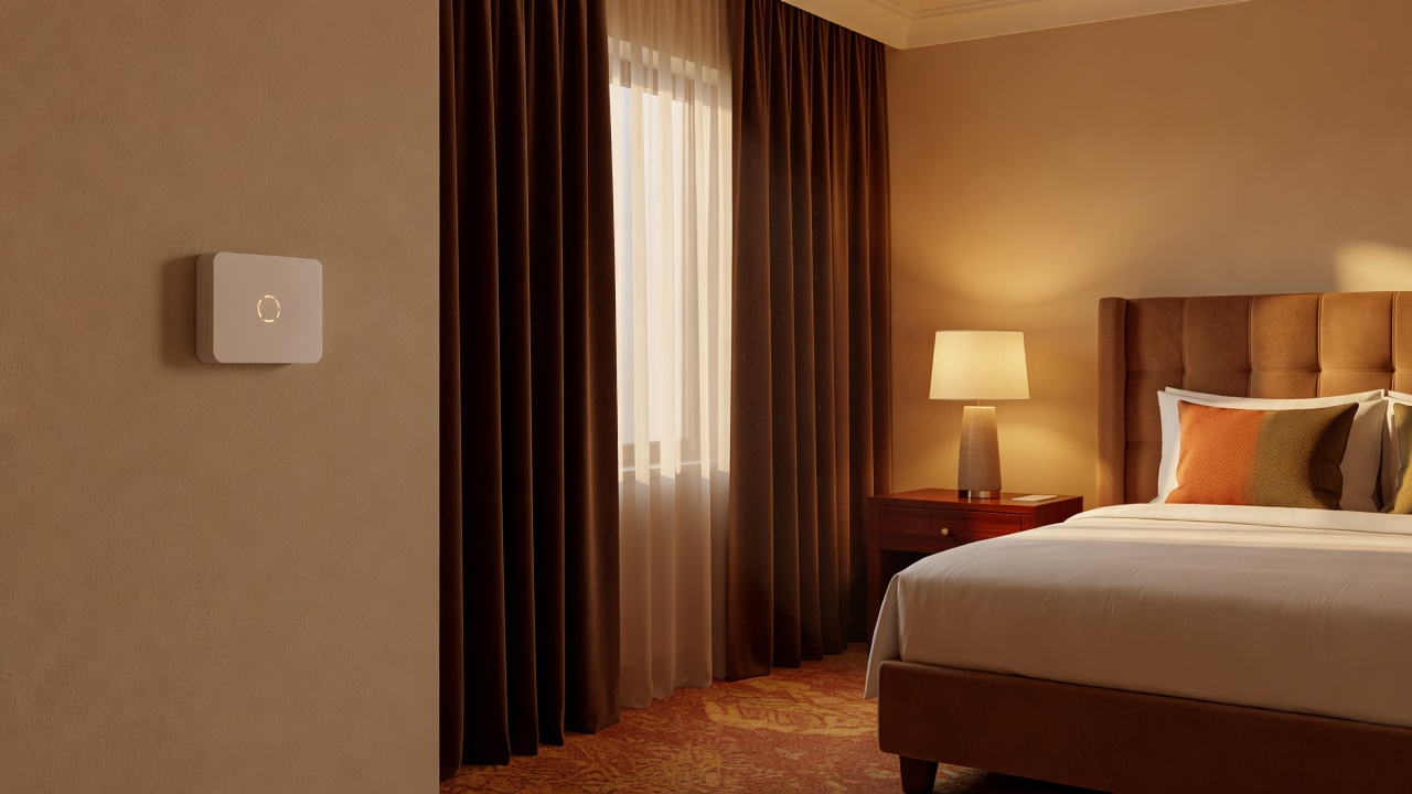 Hotel room wall thermostat beside a shaded window in a warmly furnished guest room